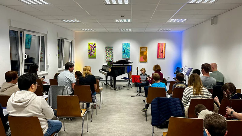 Kind spielt Gitarre vor Publikum